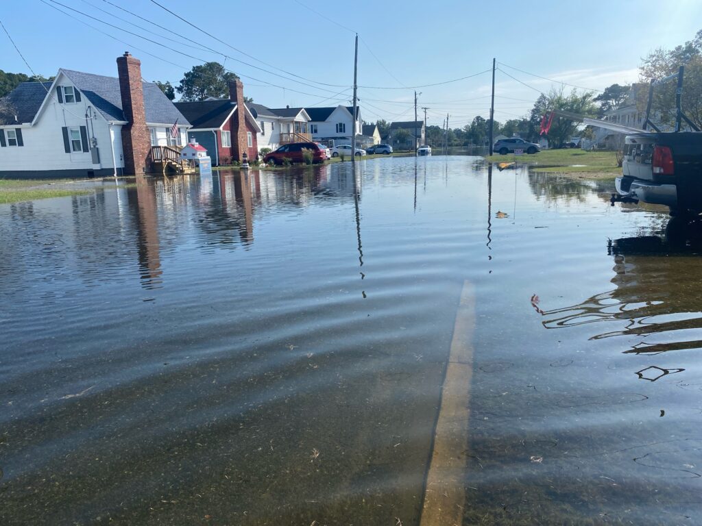a flooded street with houses and boats (MyCoast AI)