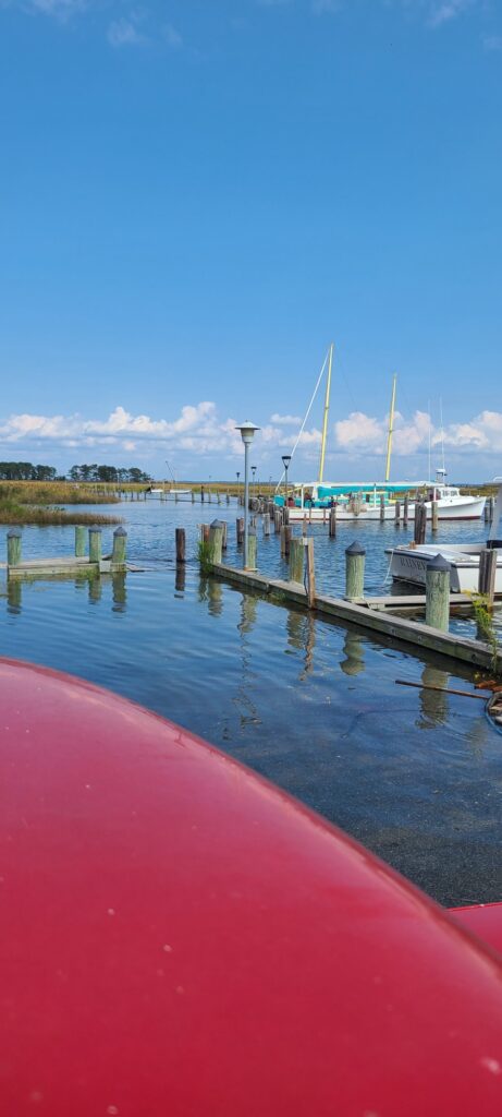 a red boat on a dock (MyCoast AI)