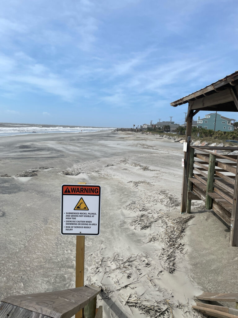 a sign on a beach (MyCoast AI)