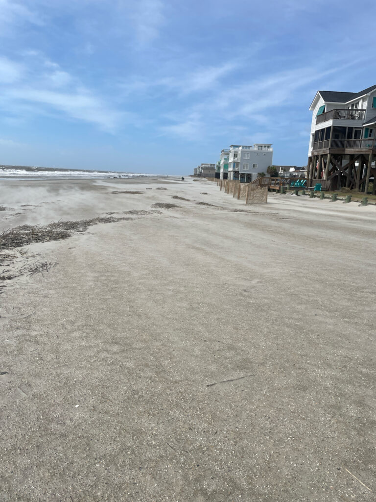 a sandy beach with buildings on the side (MyCoast AI)