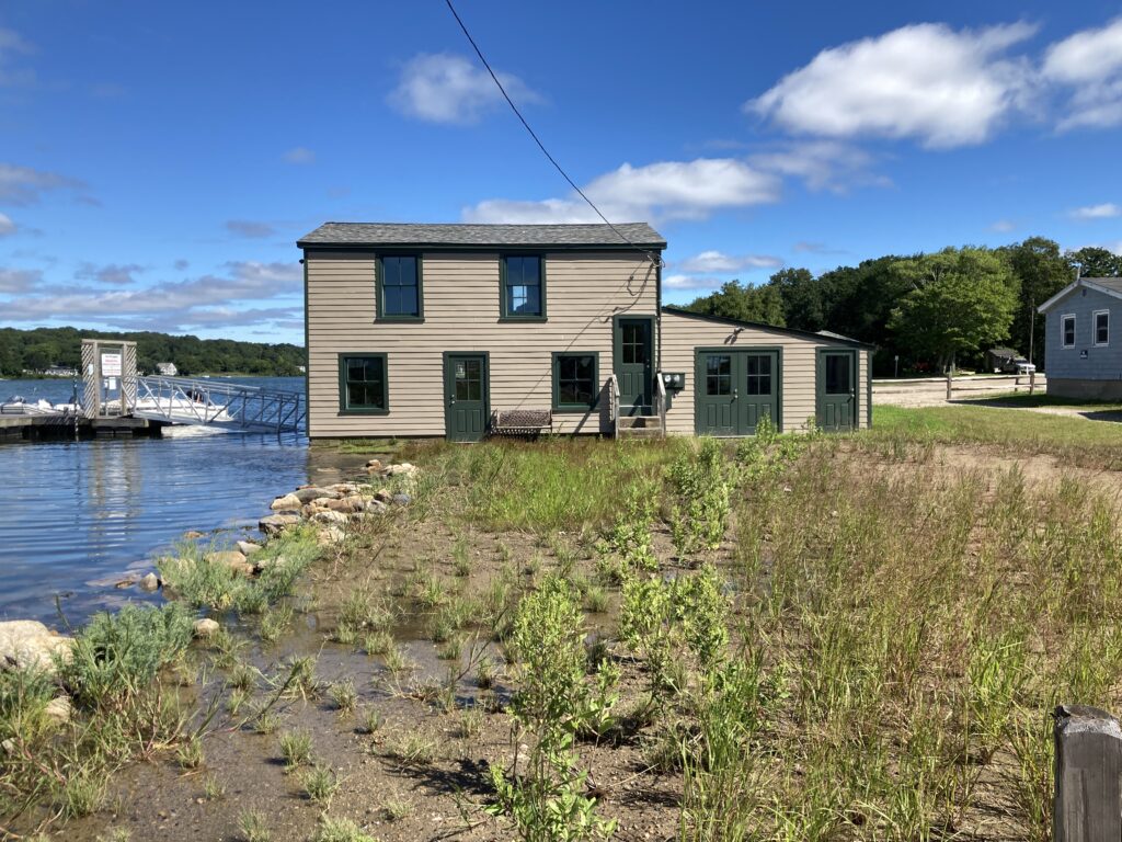 a house next to a body of water (MyCoast AI)