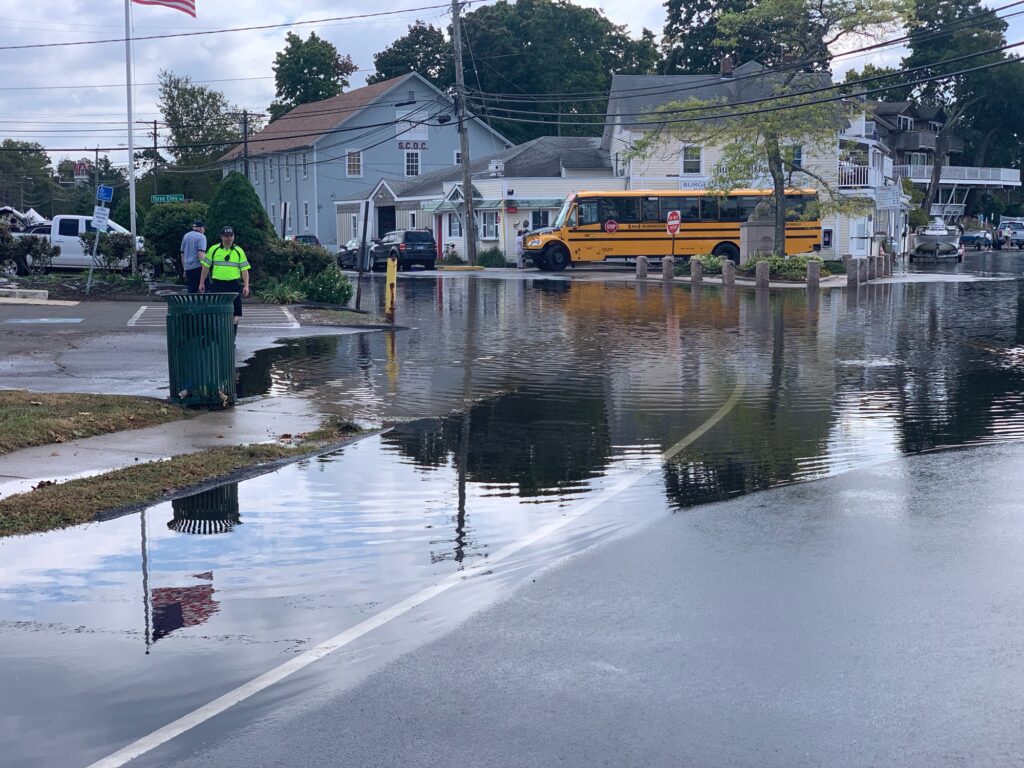 a flooded street with a bus and cars (MyCoast AI)