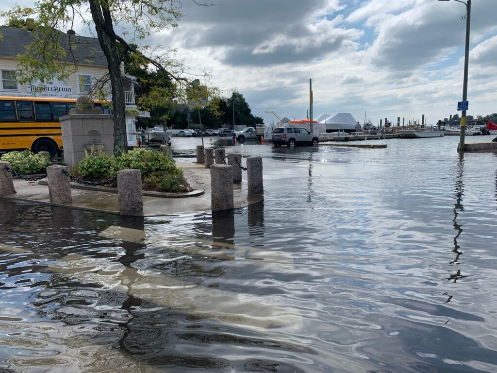 a flooded street with a bus and cars (MyCoast AI)