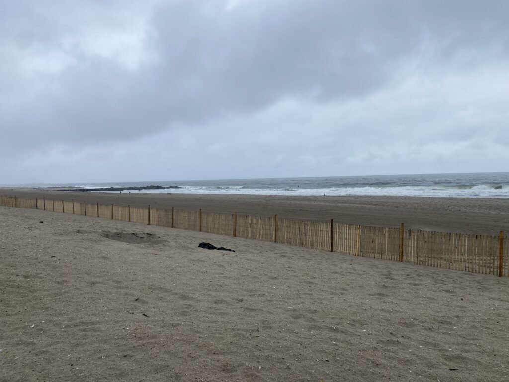a sandy beach with a fence (MyCoast AI)