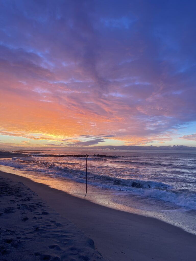 a beach with waves and a sunset (MyCoast AI)