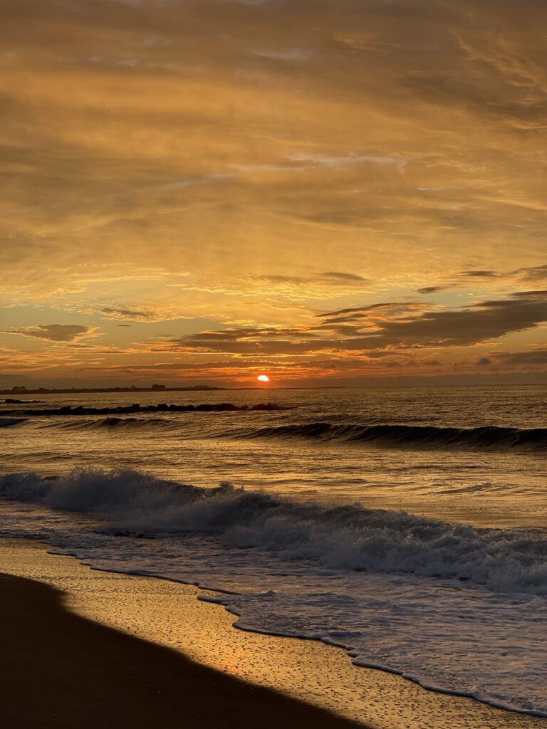 a beach with waves and a sunset (MyCoast AI)