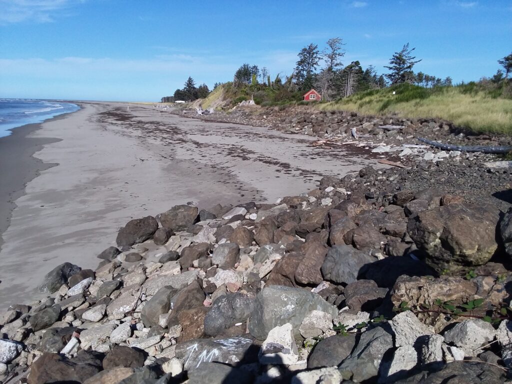 a rocky beach with a red house (MyCoast AI)
