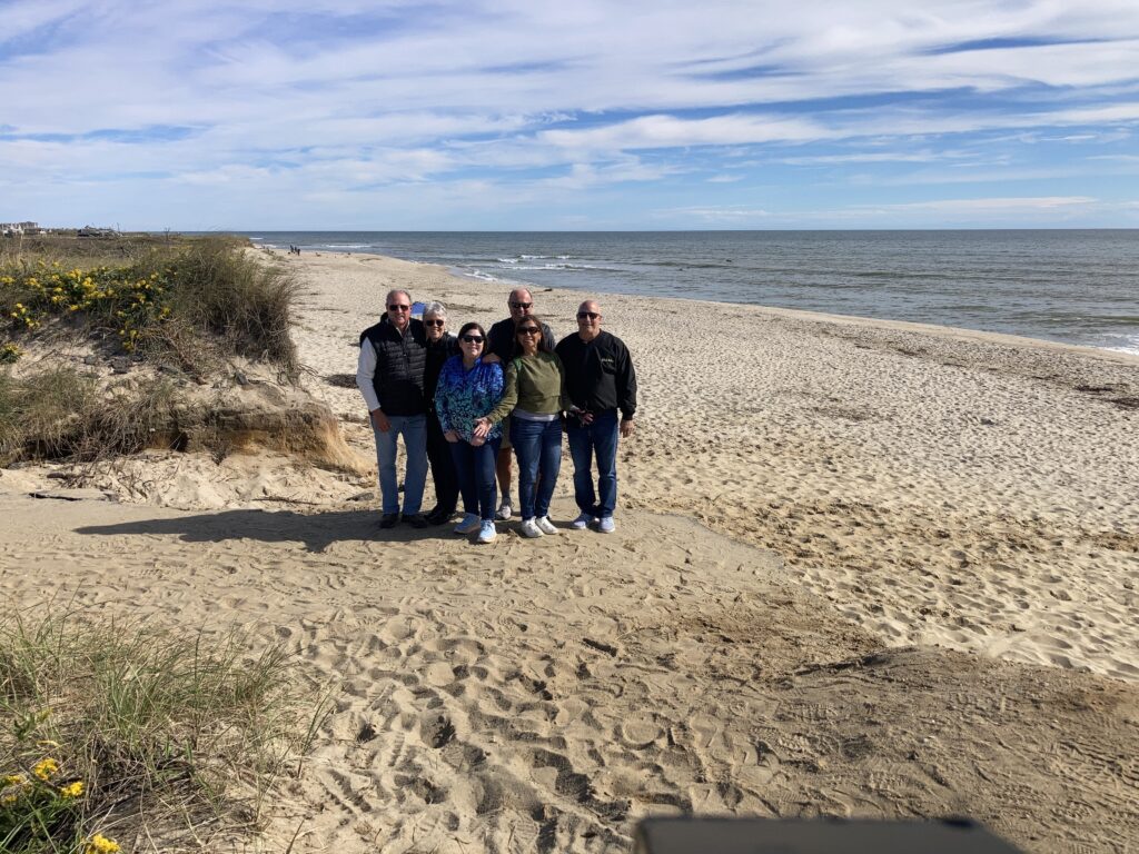 a group of people standing on a beach (MyCoast AI)