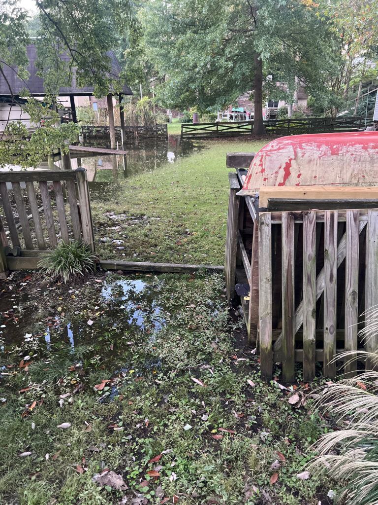 a small pond with a wooden fence (MyCoast AI)