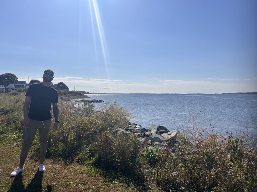 a man walking on a path by a body of water (MyCoast AI)