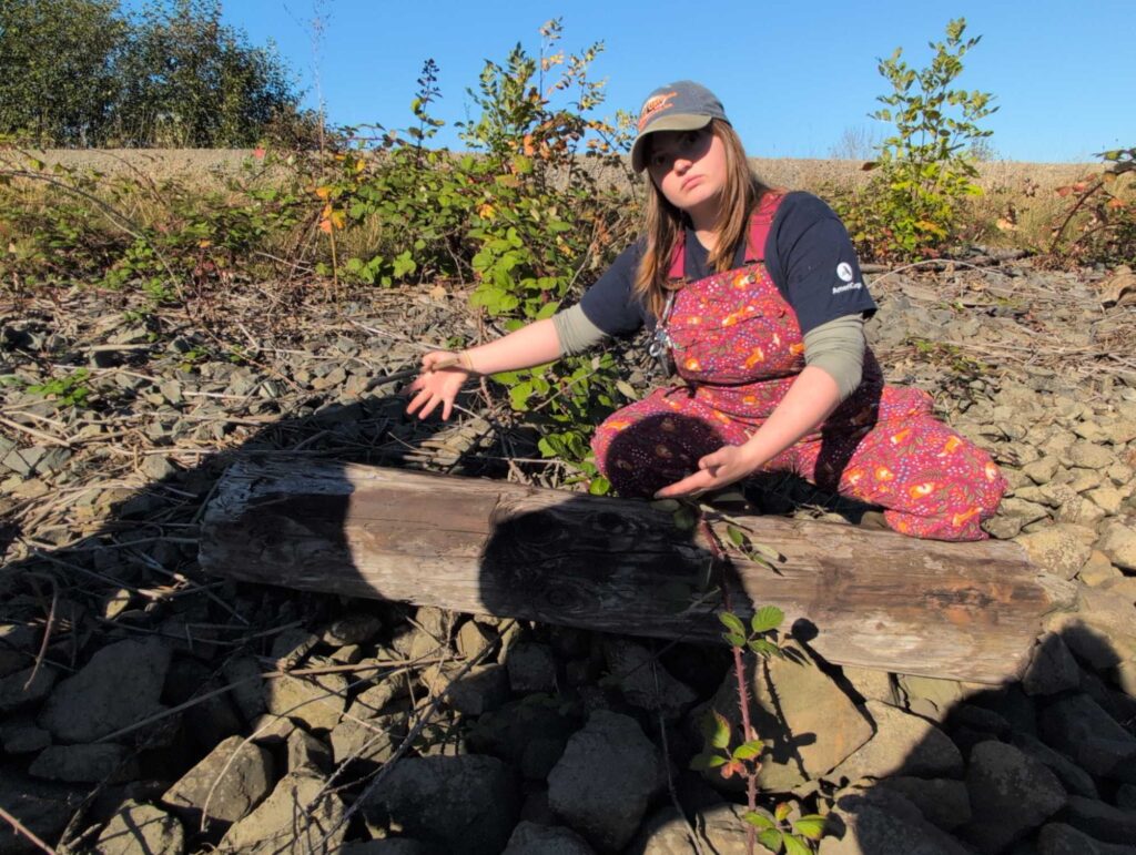 a person kneeling on rocks (MyCoast AI)