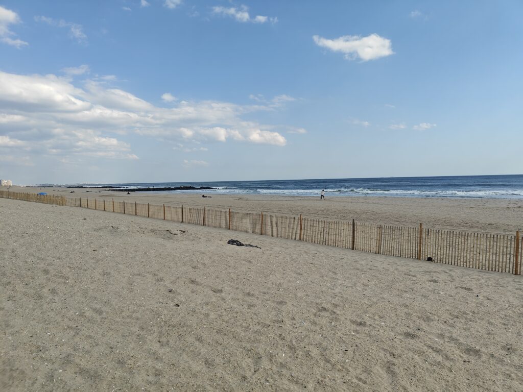a sandy beach with a fence (MyCoast AI)