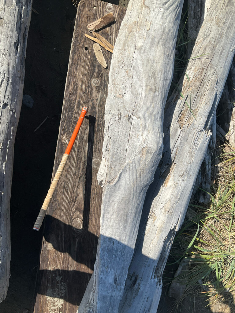 a wood fence with a stick in it (MyCoast AI)