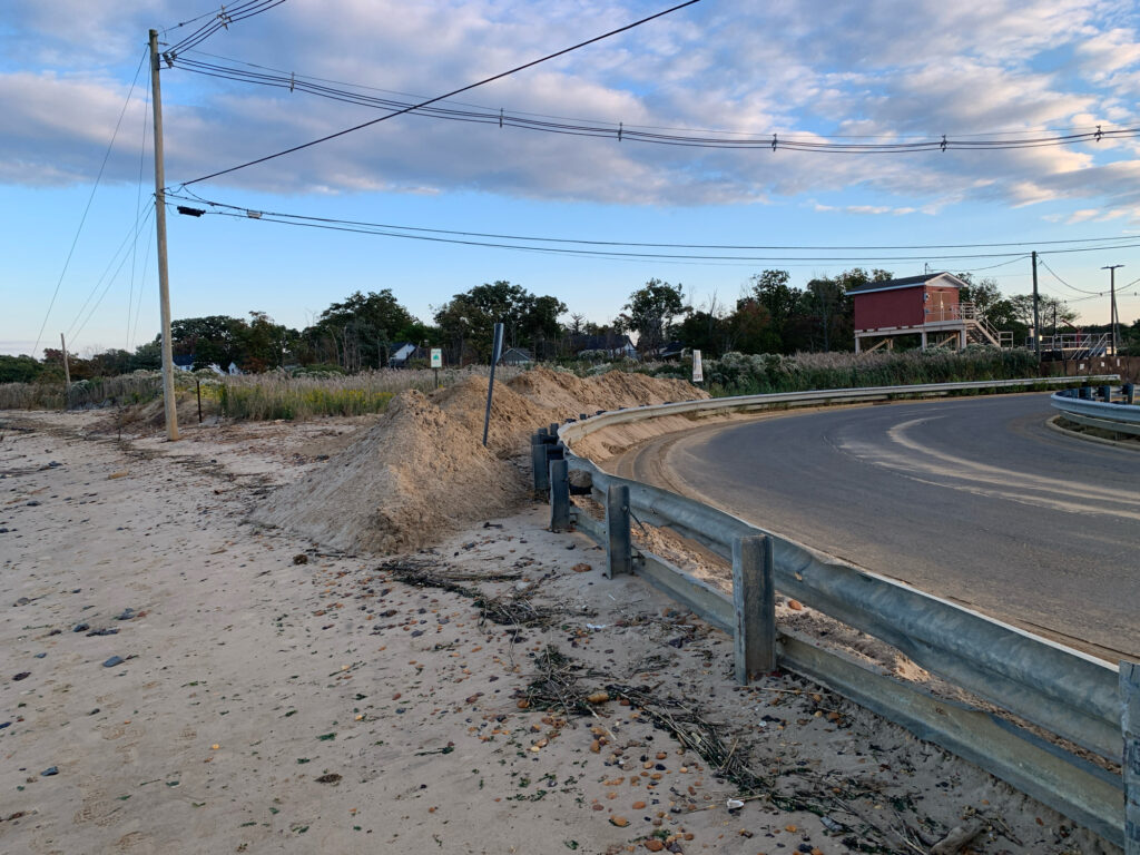 a road with a fence and a building on the side (MyCoast AI)