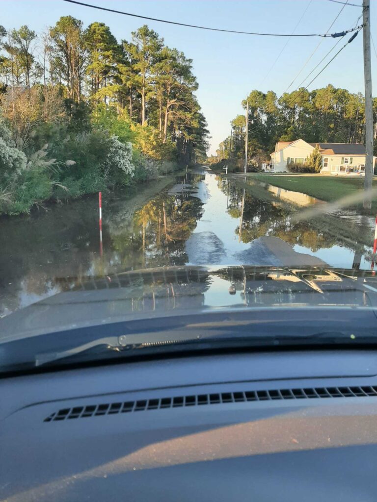 a flooded street with trees on either side of it (MyCoast AI)
