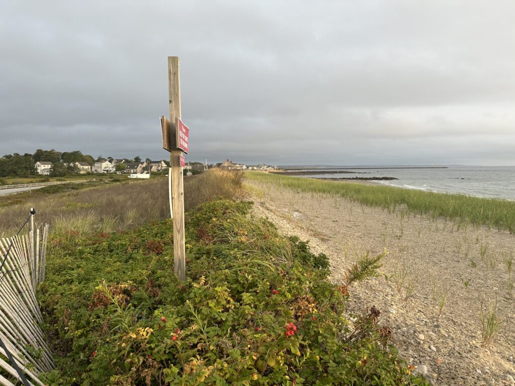 a sign on a beach (MyCoast AI)