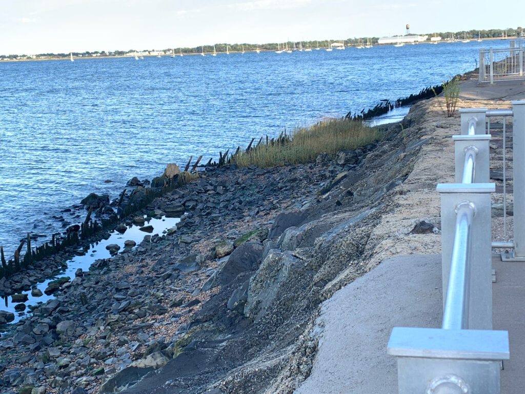 a rocky shore with a white pillar (MyCoast AI)
