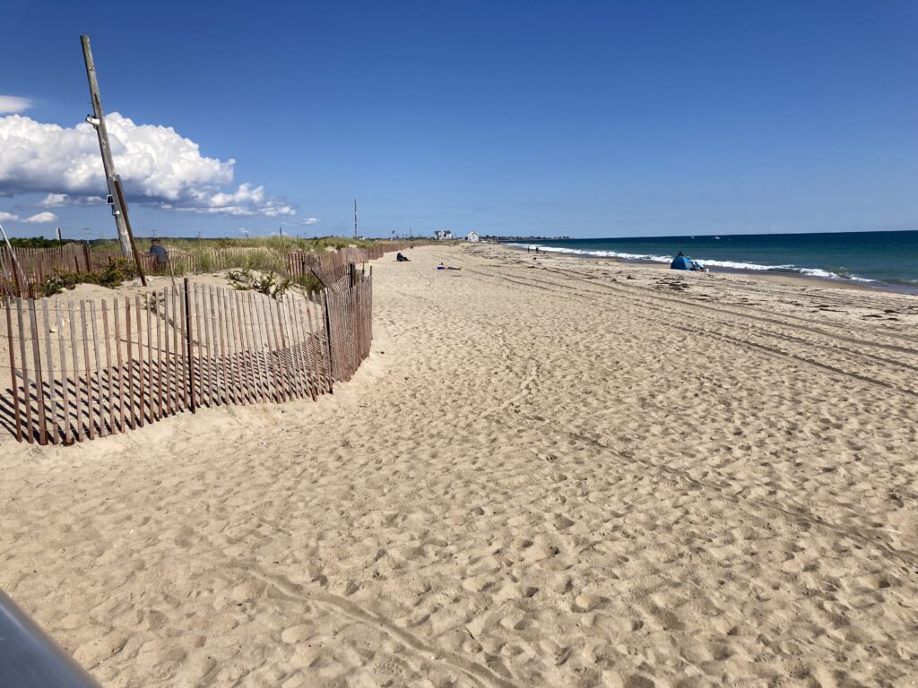 a sandy beach with a fence (MyCoast AI)