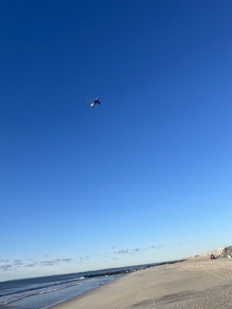 a plane flying over a beach (MyCoast AI)