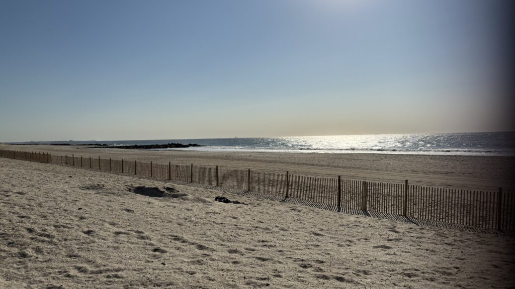 a sandy beach with a fence (MyCoast AI)