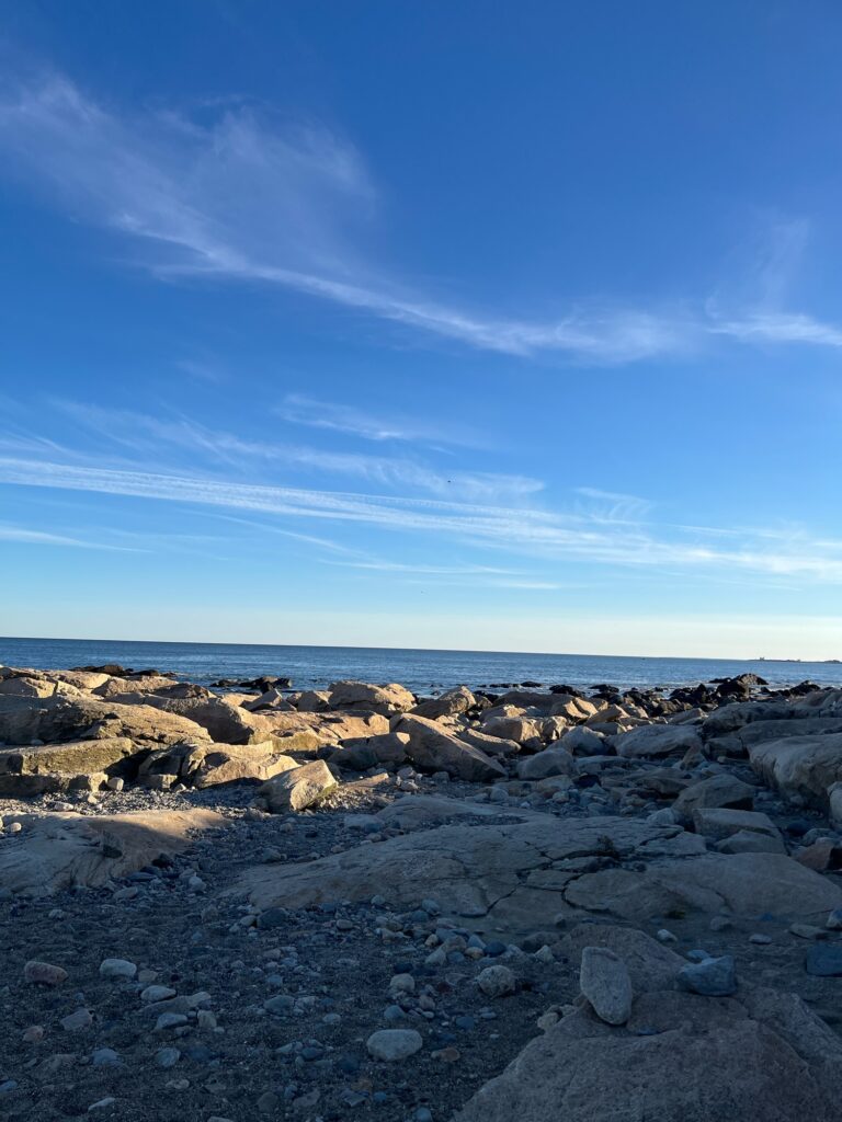 a rocky beach with blue sky and clouds (MyCoast AI)