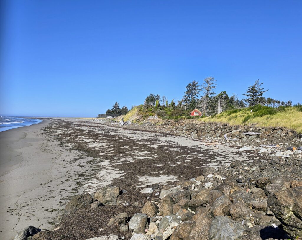 a rocky beach with a red tent (MyCoast AI)
