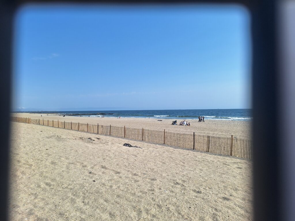 a sandy beach with a fence (MyCoast AI)