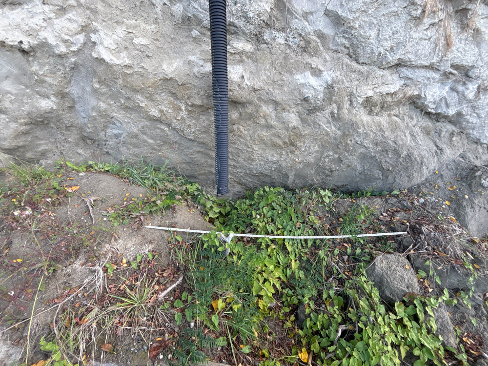 a black pipe in the ground (MyCoast AI)
