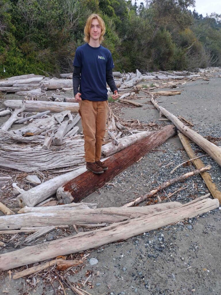 a man standing on a pile of wood (MyCoast AI)