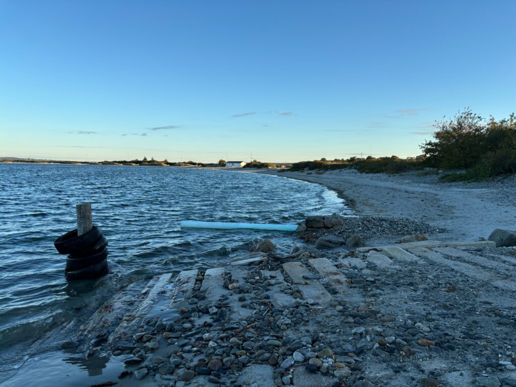 a rocky beach with a body of water in the background (MyCoast AI)