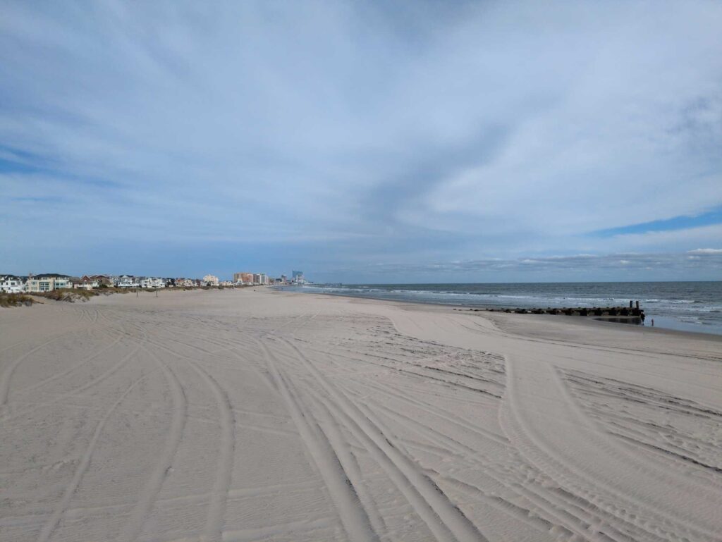 a sandy beach with buildings in the background (MyCoast AI)