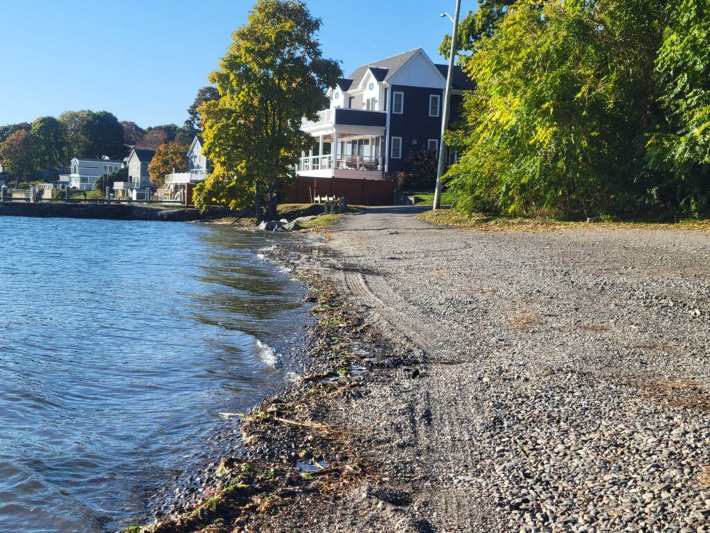 a rocky beach with houses along it (MyCoast AI)
