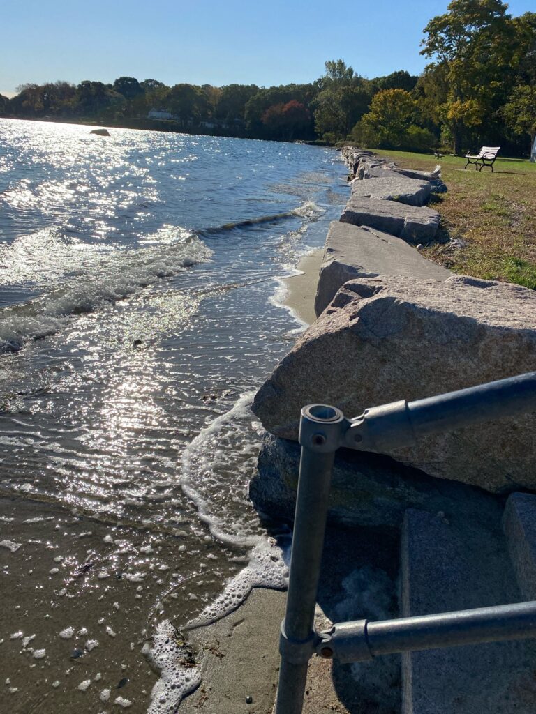 a river with rocks and a railing (MyCoast AI)