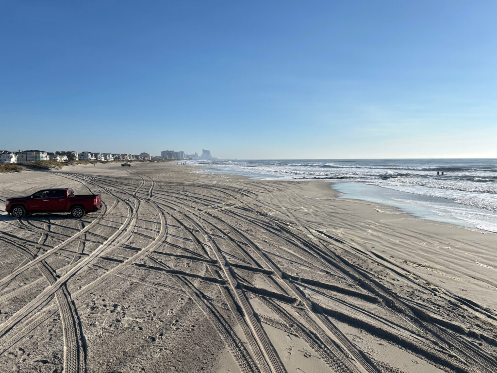 a red car on a beach (MyCoast AI)
