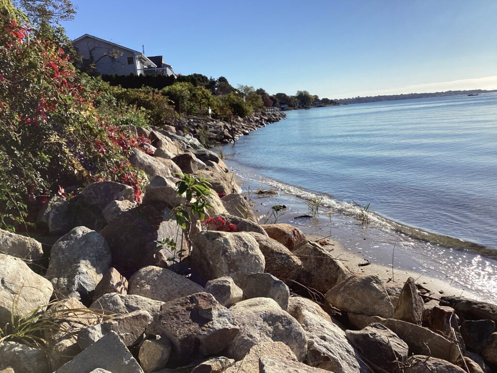 a rocky beach with a house (MyCoast AI)