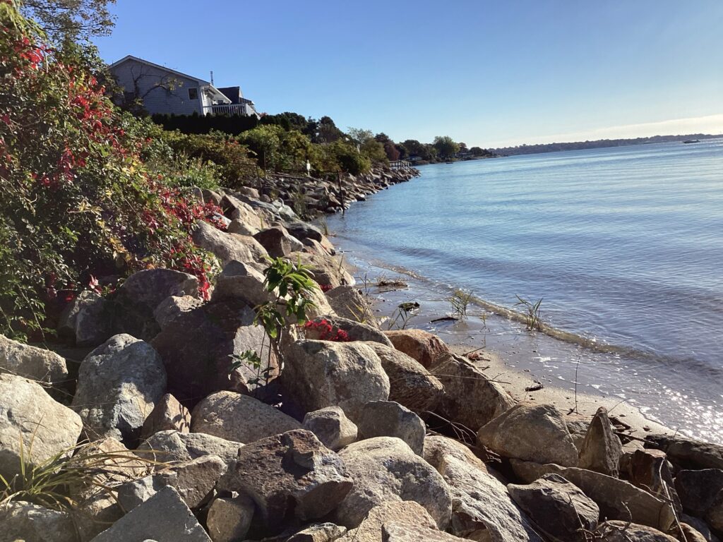 a rocky beach with a house (MyCoast AI)