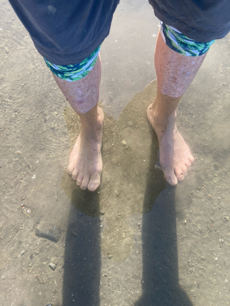 a man's feet in the sand (MyCoast AI)