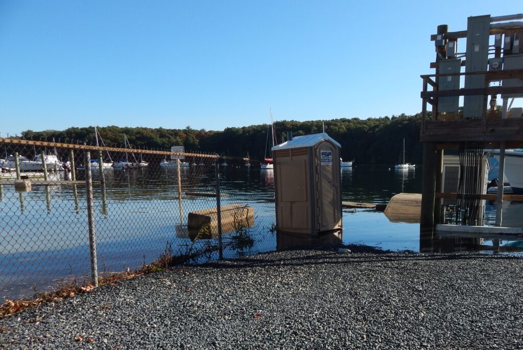 a dock with a metal box on it by a body of water (MyCoast AI)