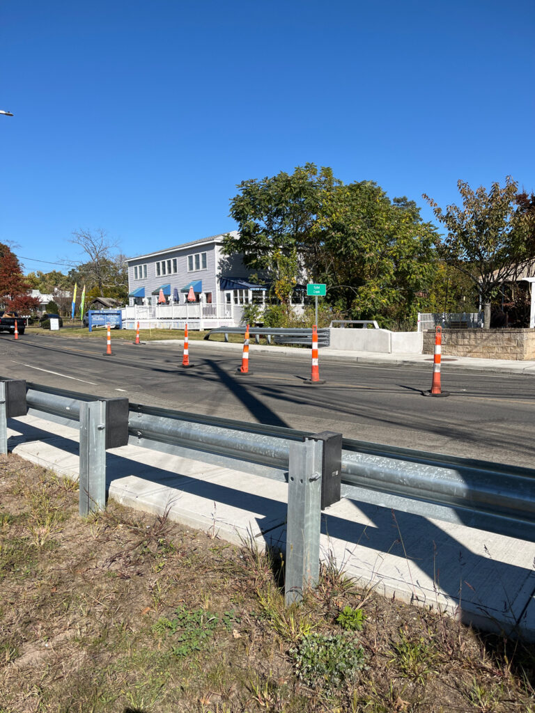 a road with a fence and a building in the background (MyCoast AI)