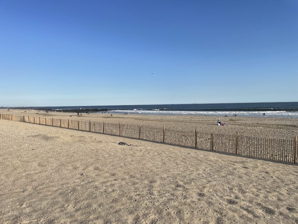 a sandy beach with a fence (MyCoast AI)