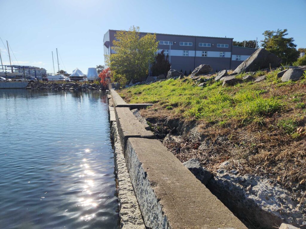 a building next to a body of water (MyCoast AI)