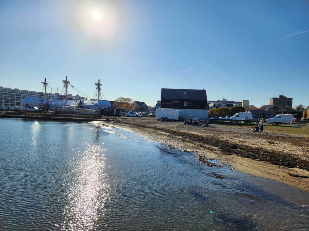 a body of water with a building and a boat in the background (MyCoast AI)