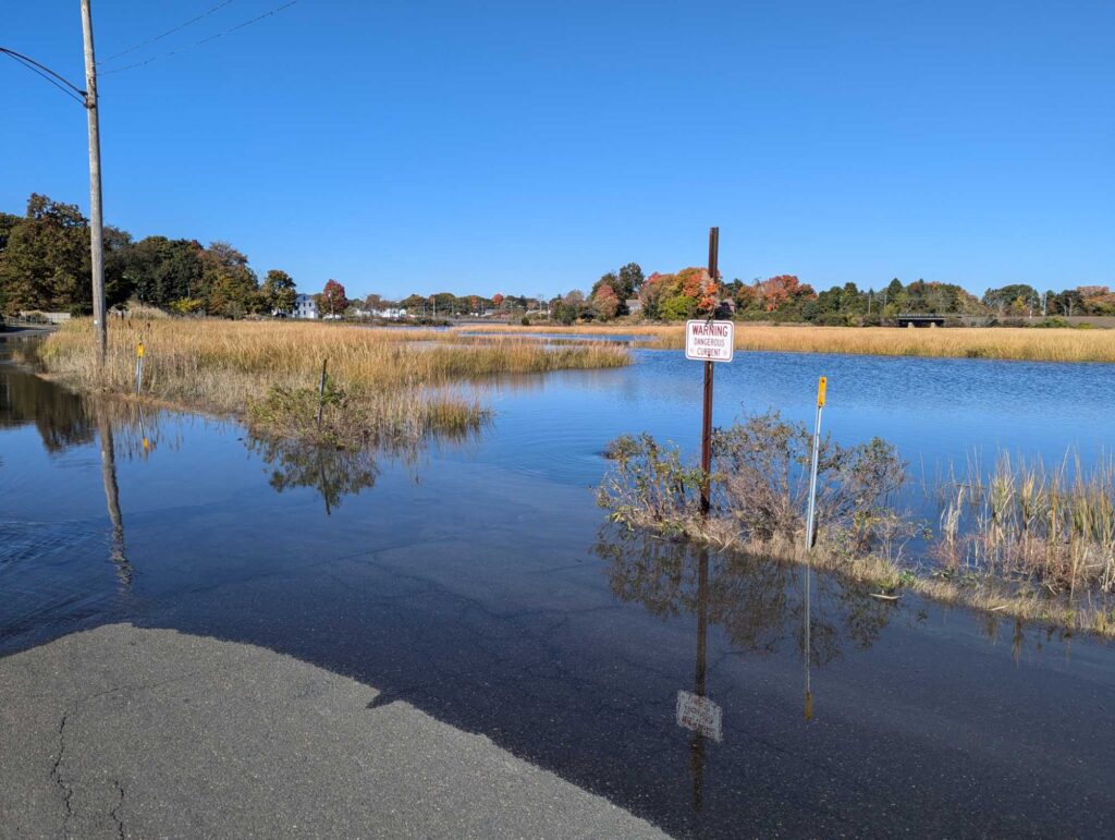 a flooded road with a sign (MyCoast AI)