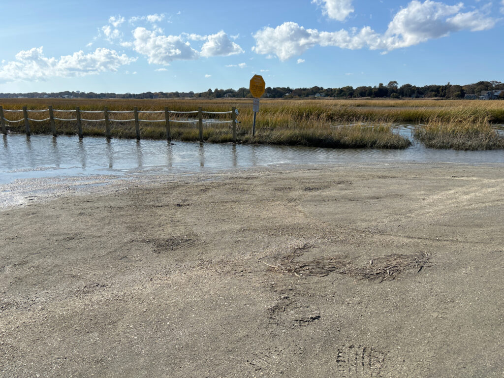 a beach with a fence and a body of water (MyCoast AI)