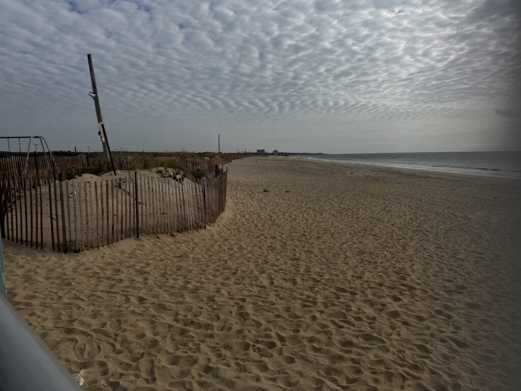 a sandy beach with a fence (MyCoast AI)