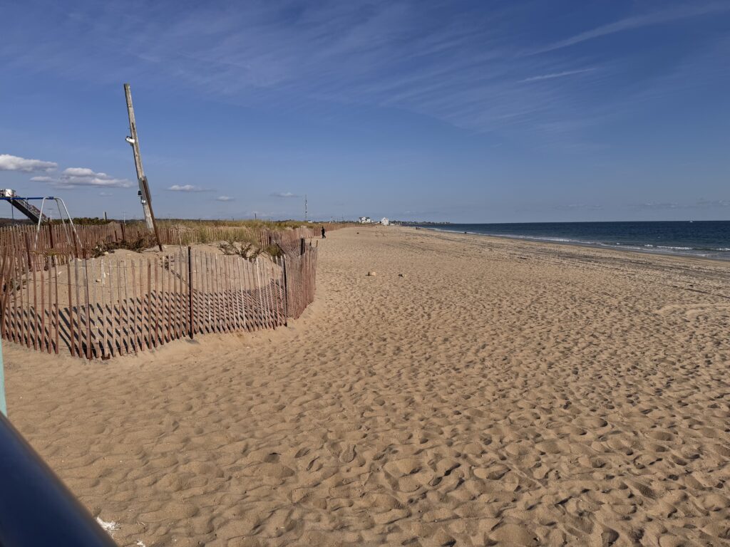 a sandy beach with a fence (MyCoast AI)