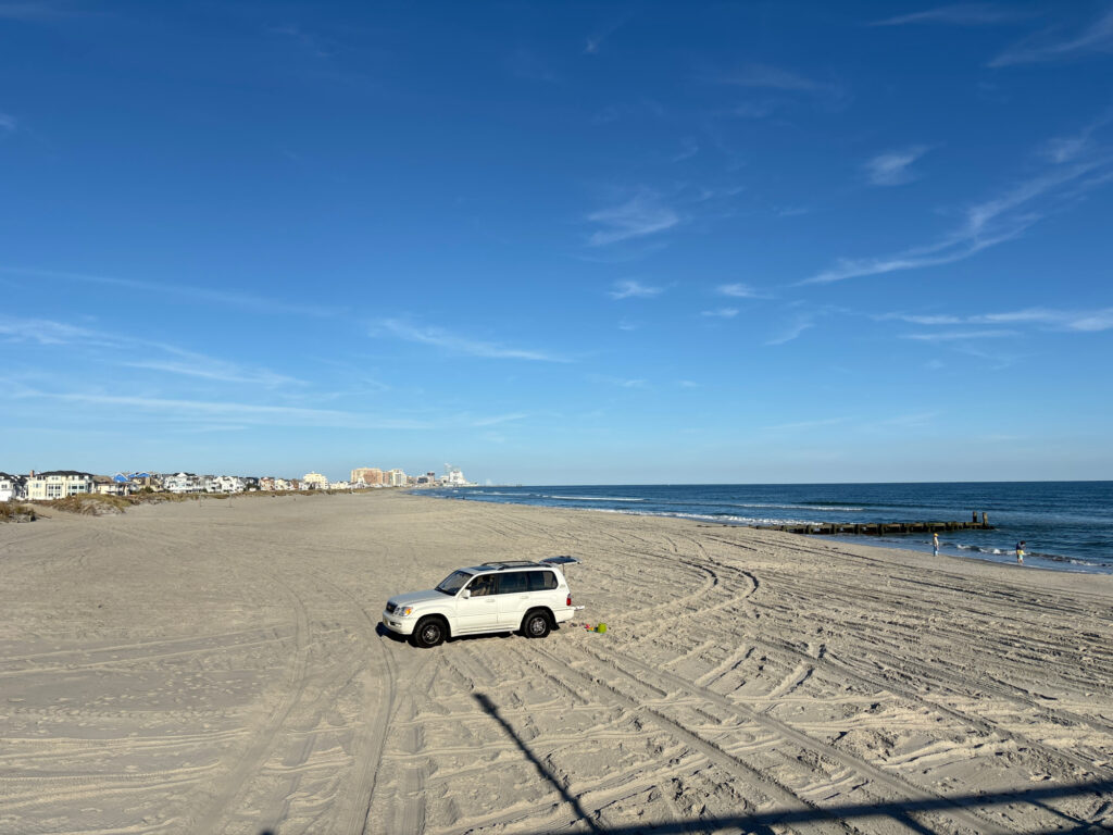 a white car parked on a beach (MyCoast AI)