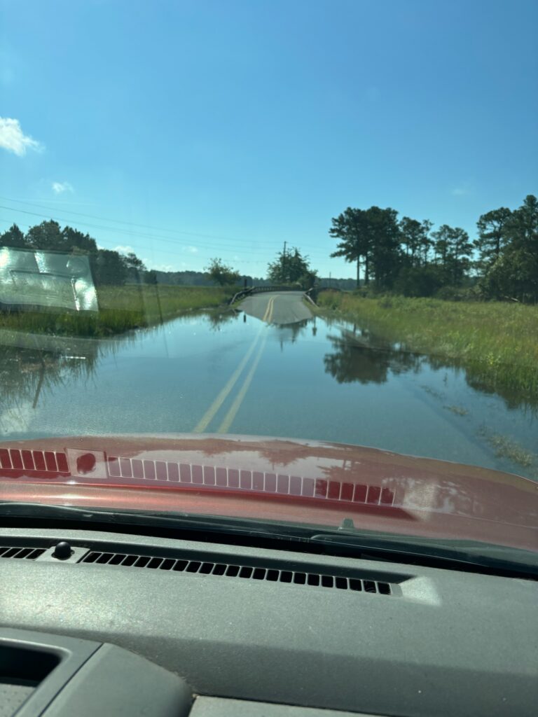 a car driving on a flooded road (MyCoast AI)