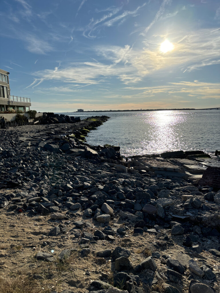a rocky beach with the sun setting (MyCoast AI)