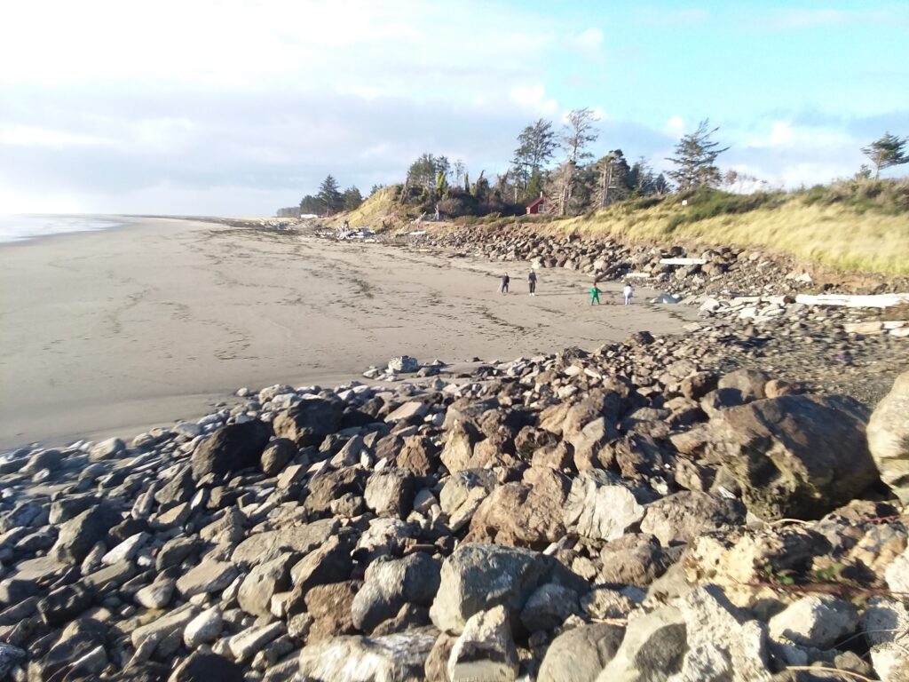 a rocky beach with people walking on it (MyCoast AI)
